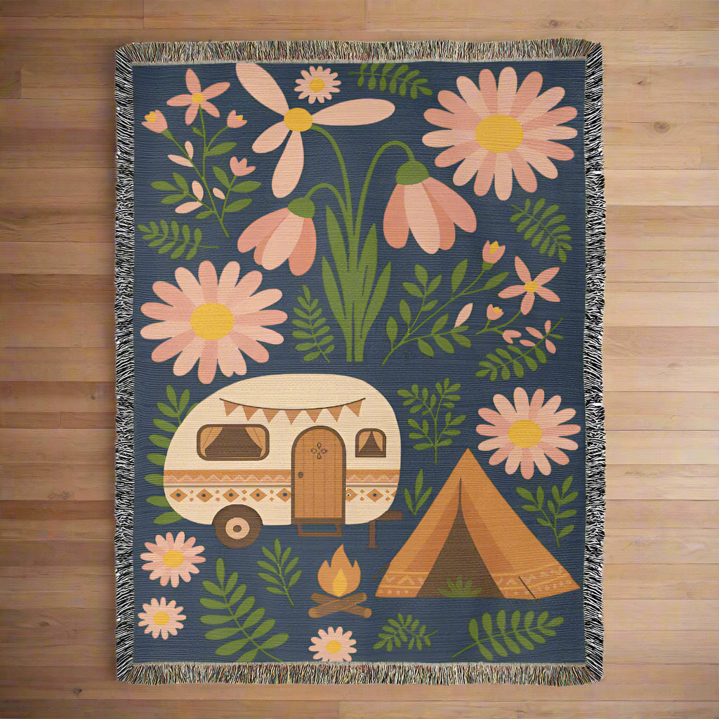 Floral and camping-themed blanket with a camper and tent design on a blue background.