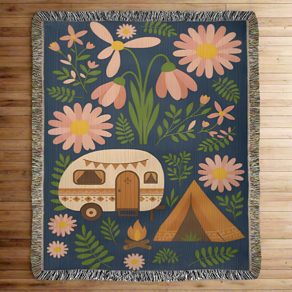 Woven blanket with floral and camping-themed design on a blue background