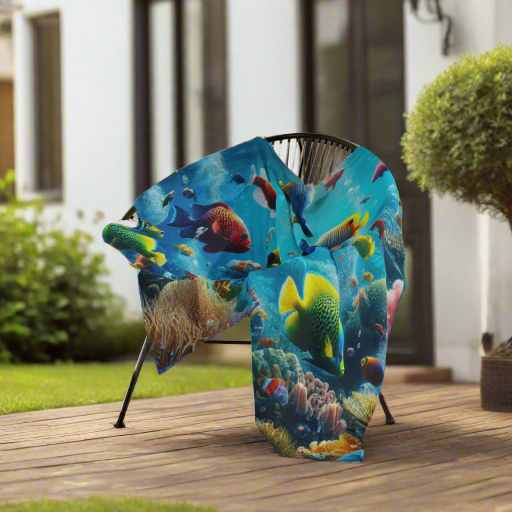 Colorful fish-themed blanket draped over a chair.
